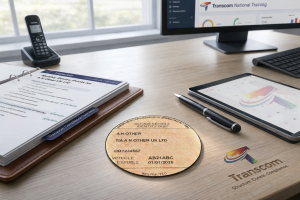 Restricted operator compliance support desk setup with operator licence disc, compliance review file, calendar tablet and Transcom branding